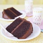 two plates of chocolate cake wedge and drink cups