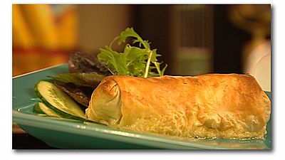 Baked Filo Parcel on a plate with greens