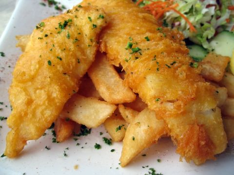Fish and chips on white plate.