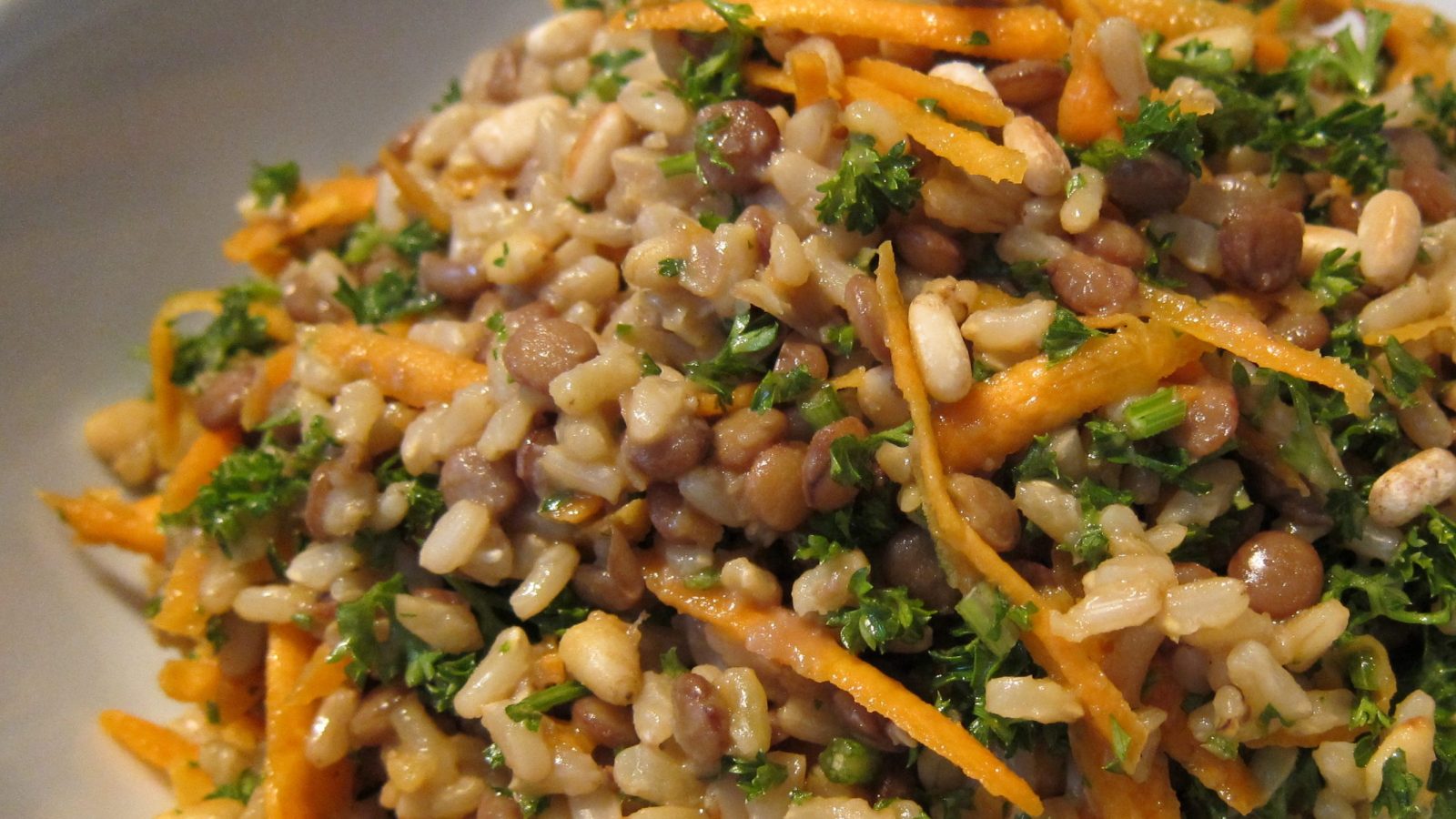 Brown rice , lentil, carrot and parsley salad close up
