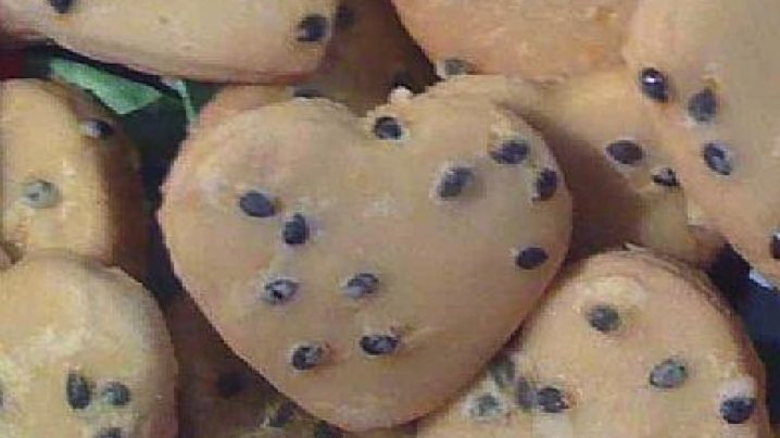 Heart shaped cookies iced with passionfruit icing.