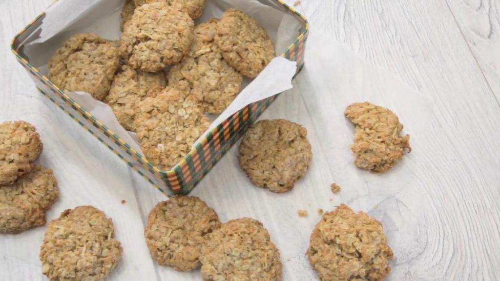 Oat biscuits in square tin and around it.