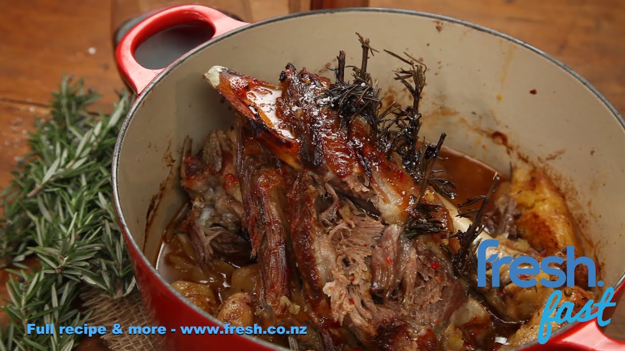 Slow roast lamb in a casserole dish with rosemary and sweet chili sauce