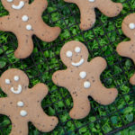 healthy ginger bread men laid onto of green grass