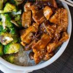 A bowl of brown ribs and broccoli on rice.