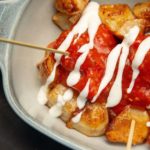 Raosted potatoes smothered in sauce