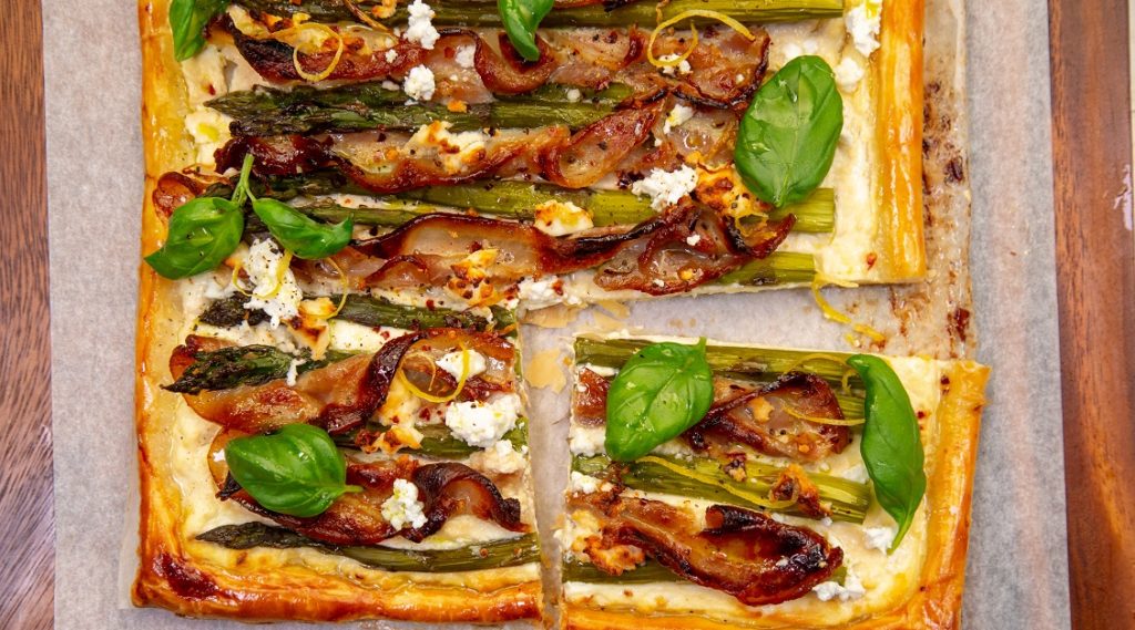 Bacon, asparagus and feta cheese rectangle open top pie, cut piece separated a little.