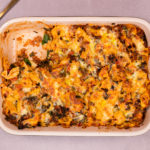 Pasta bake in a rectangle dish with handles with a spoon