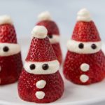 4 Santa strawberries on a white plate