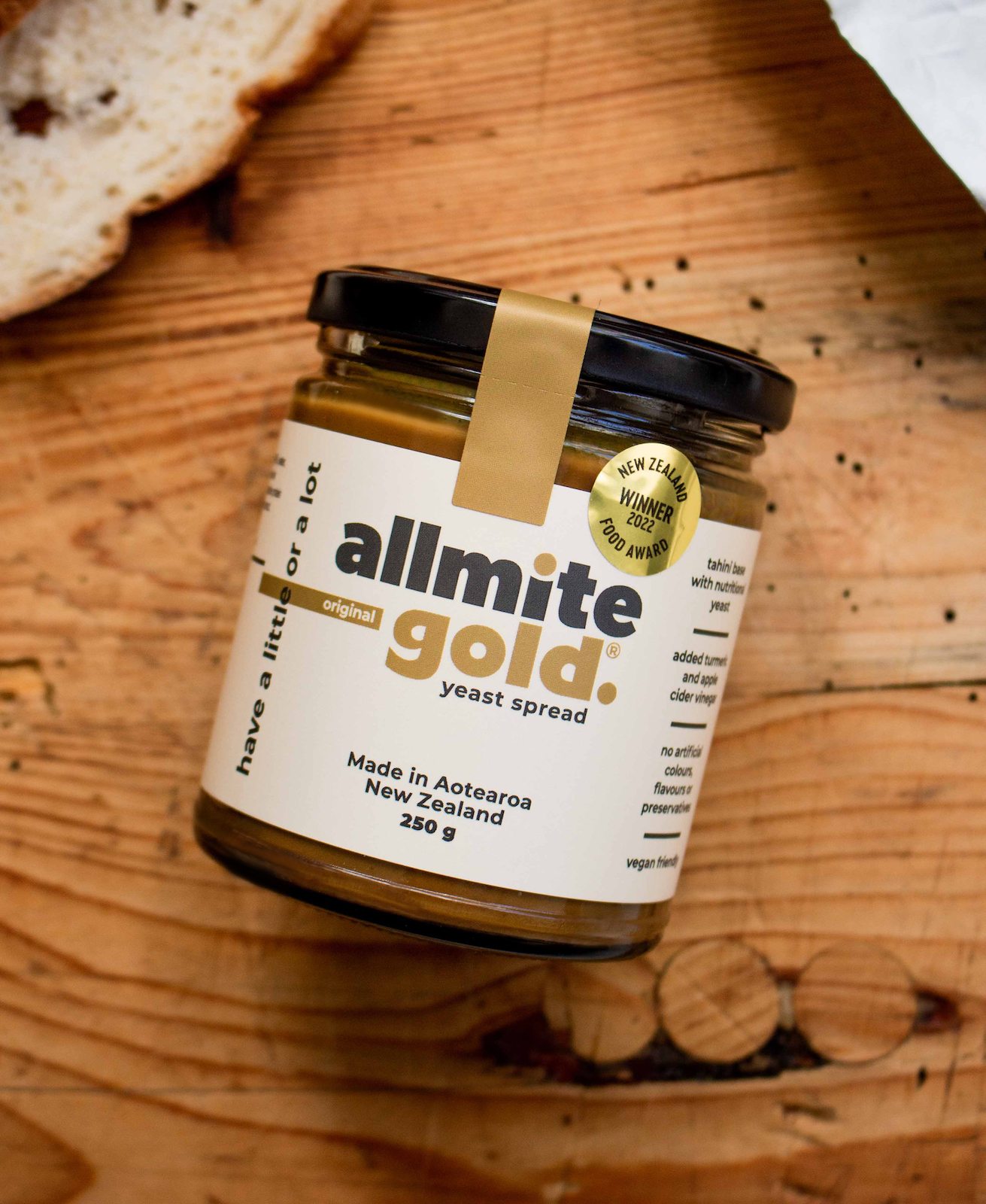 A jar of allmite gold on a wooden bread board