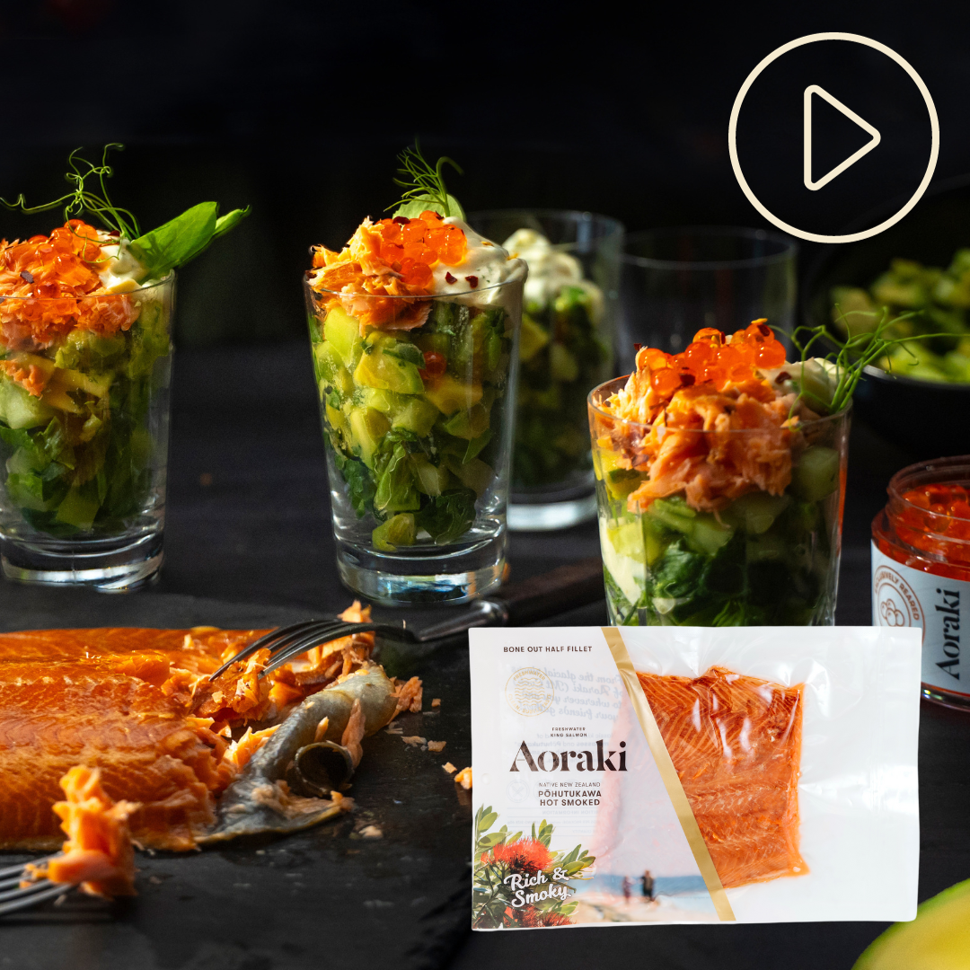 Salmon and avocado verrines in little glasses with a piece of hot smoked salmon and a pack of Aoraki Pohutukawa smoked salmon