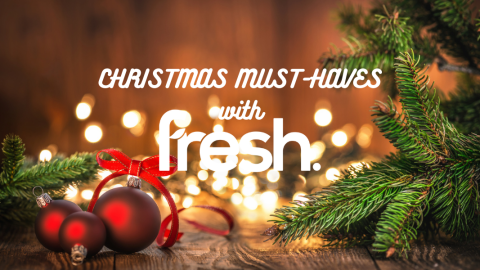 Christmas must-haves with Fresh text with red baubles, fairy lights and pine tree