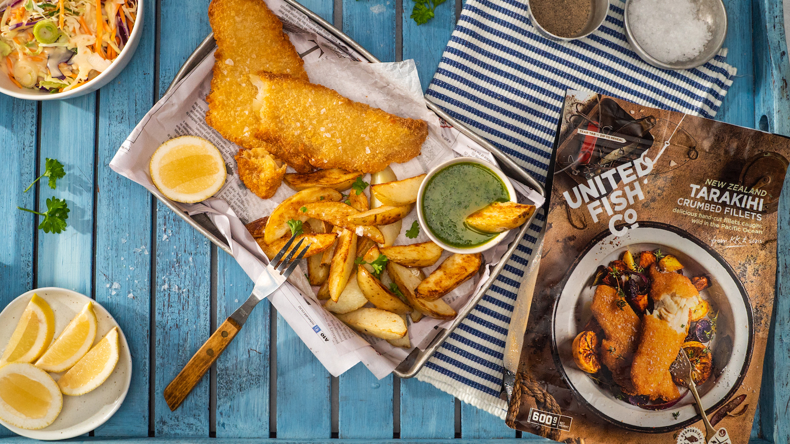 June Must-Haves 2023 - Crumbed fired fish with potato wedges, herby sauce, and a bag of United Food Co crumbed tarakihi fillets