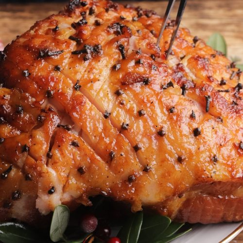 Close up of a baked Christmas ham on a bone.