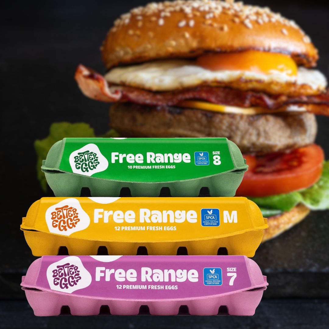 A hamburger with a stack of Better Egg cartons in front in three different egg sizes