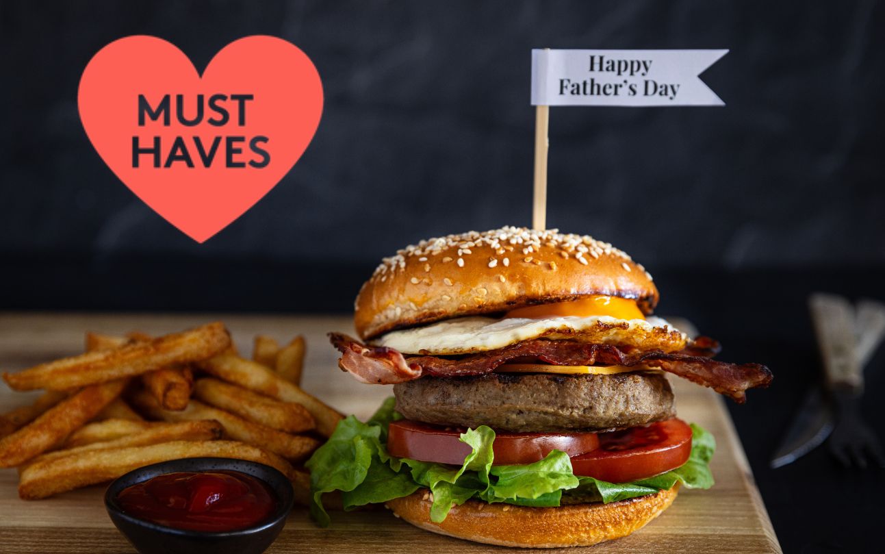 A hamburger with a little flag stuck in the top saying happy father's day, and a red heart in a corner of the image saying Must Haves