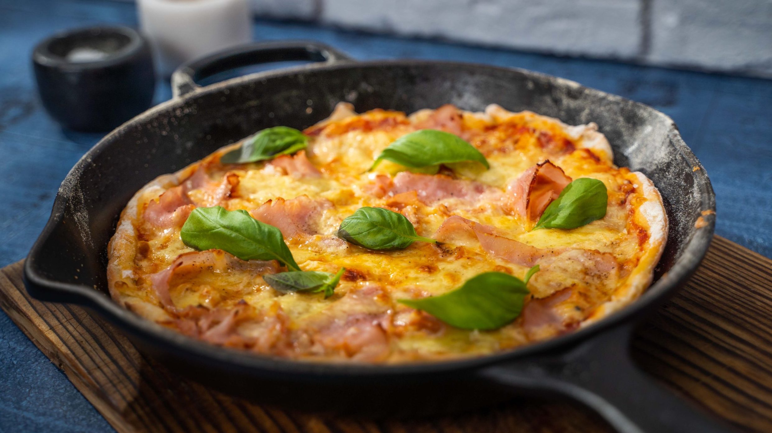 Ham and pineapple pizza in a skillet