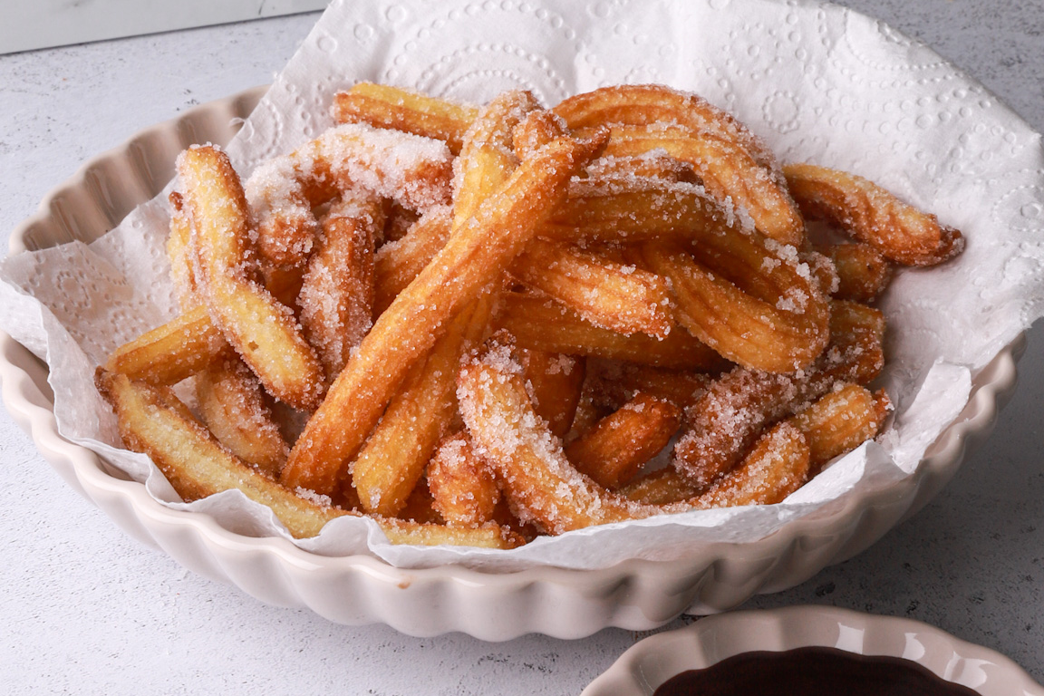 Homemade churros in a serving bowl