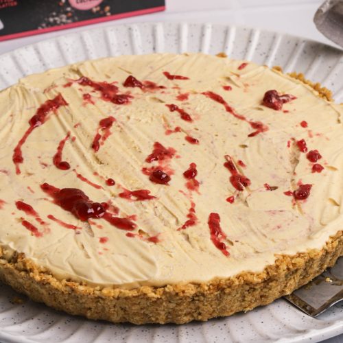 A whole cream pie with red jam twirls