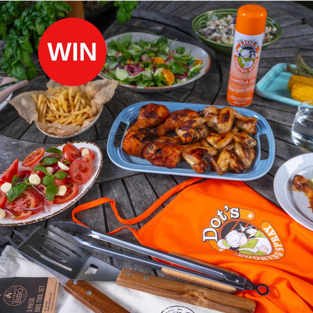 An outdoor table with BBQ chicken, salads, a can of Dot's cooking spray, a Dot's apron and some BBQ utensils with a Win message