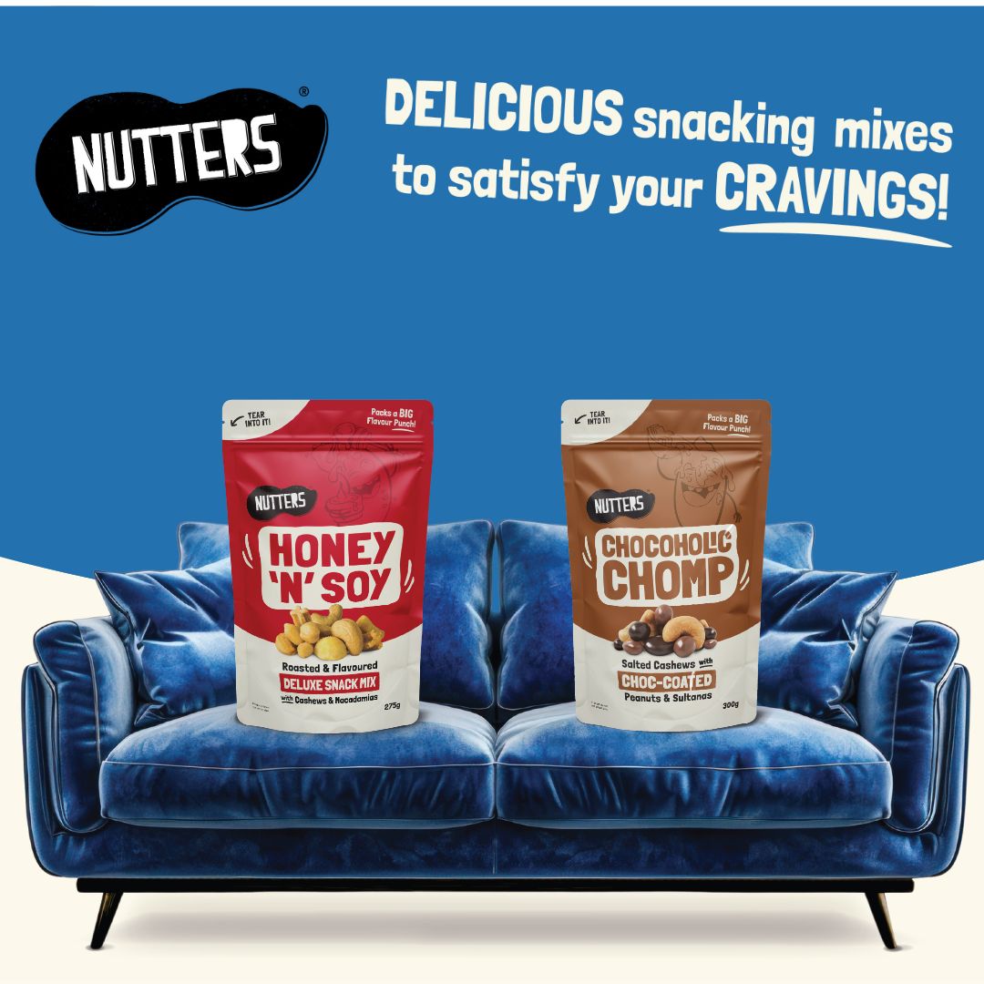 A packet of Nutters Honey and Soy mix and a packet of Nutters Chocoholic Chomp mix sitting on a blue sofa