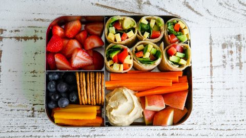 Healthy lunchboxes with veggies, carrots, hummus and crackers