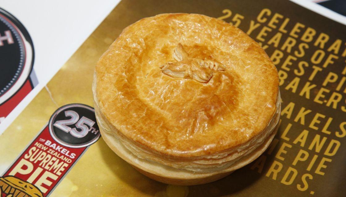 A pie photographed next to the 25th supreme pie award ribbon