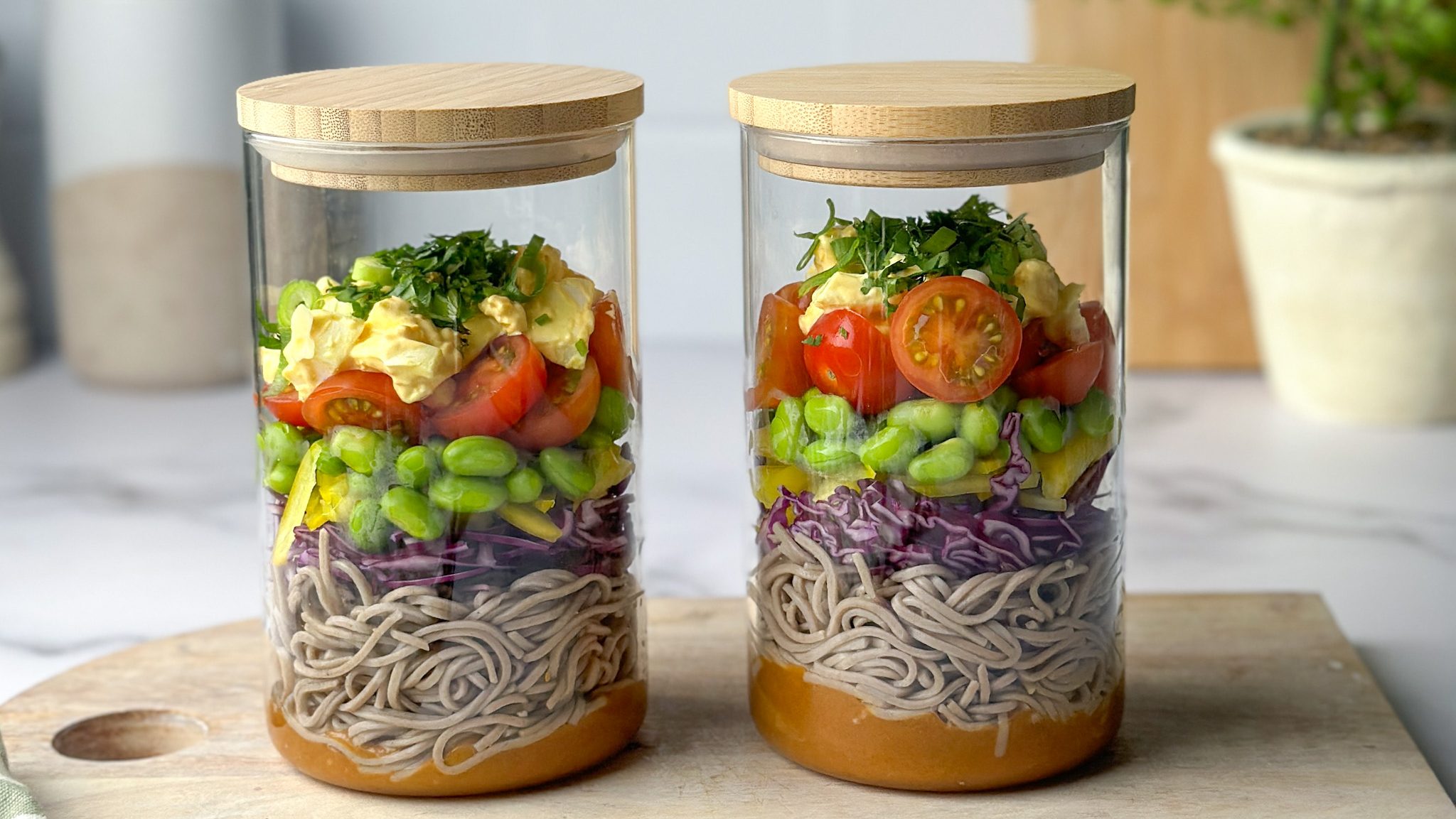 Layered soba noodle salad in two jars.