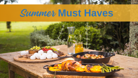 A table in a garden with cooked chicken and mini pavlovas and the title Summer Must Haves