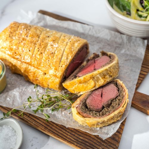 Venison Wellington sliced and served on a board
