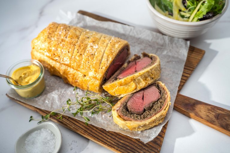Venison Wellington sliced and served on a board